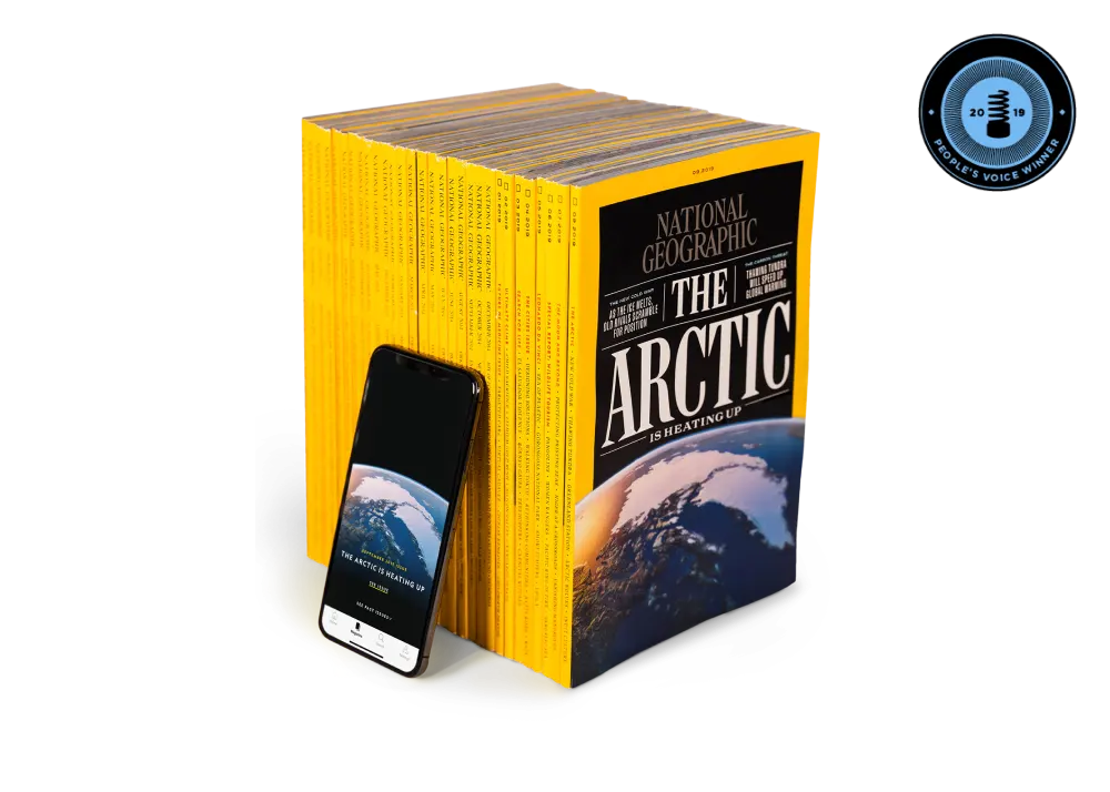 An iPhone with the National Geographic app leaning against National Geographic magazines